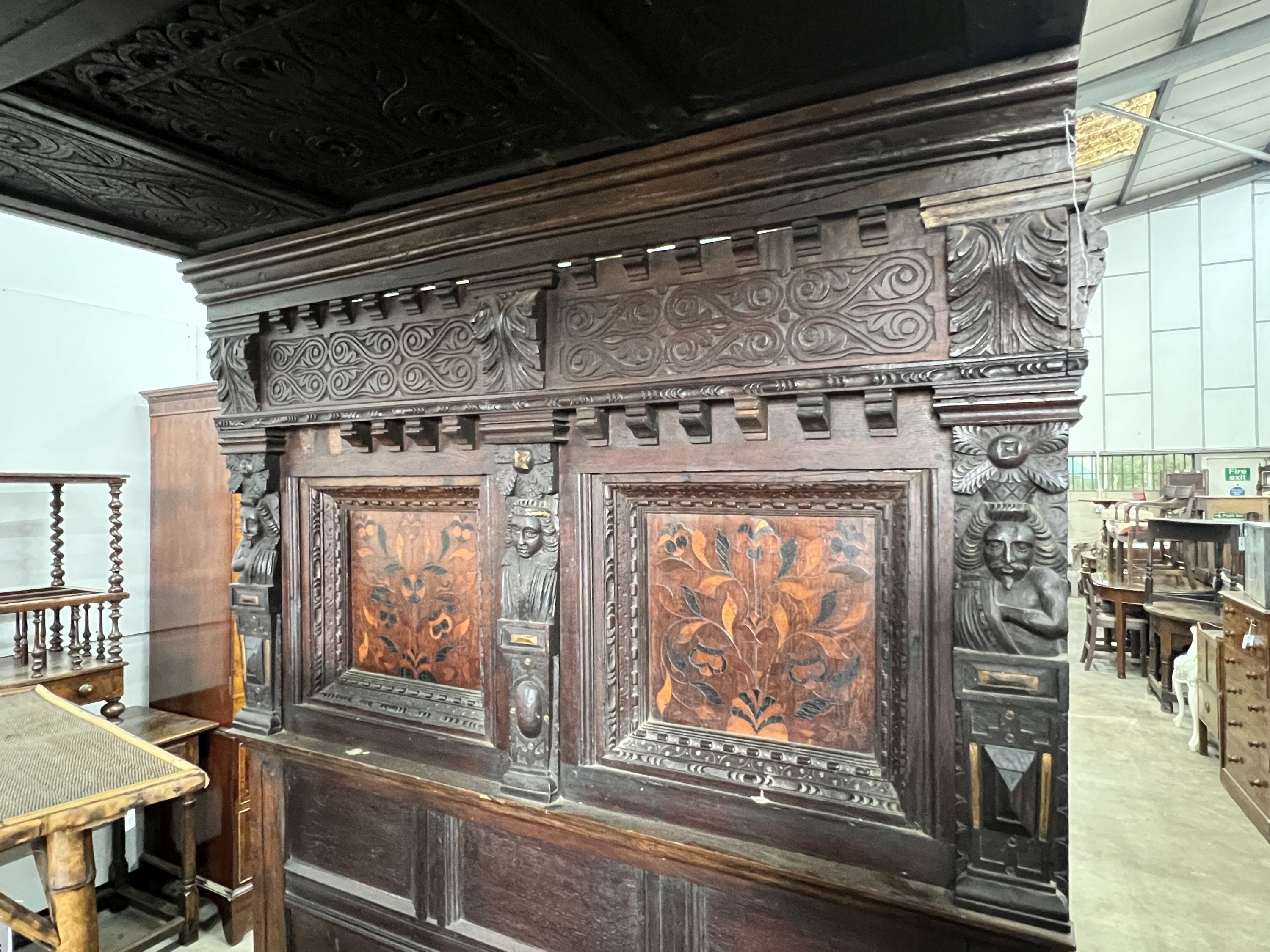 A 17th century style oak tester bedstead, inset with marquetry panels, length 196cm, depth 135cm, height 204cm